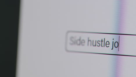 Close-Up-Of-Screen-With-Person-Typing-Side-Hustle-Jobs-Into-Computer-Search-Engine