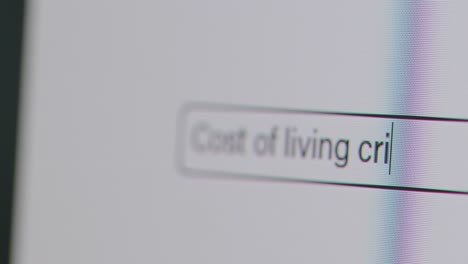 Close-Up-Of-Screen-With-Person-Typing-Cost-Of-Living-Crisis-Into-Computer-Search-Engine