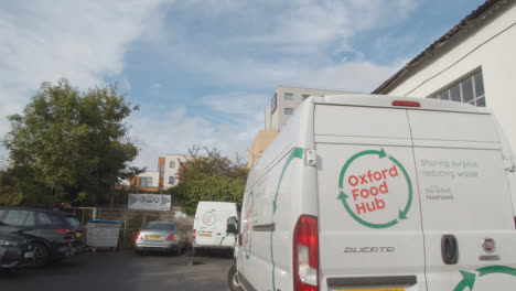 Exterior-Of-UK-Food-Bank-Building-With-Vans-Making-Deliveries-1