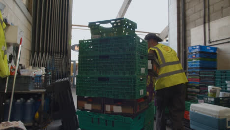 Loading-Bay-Of-UK-Food-Bank-Building-With-Food-Being-Loaded-Into-Vans-
