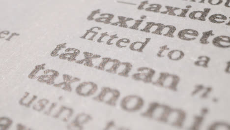 Close-Up-On-Page-Of-Dictionary-With-Definition-Of-Word-Taxman