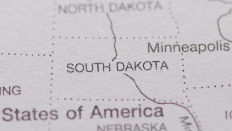 Close-Up-On-Page-Of-Atlas-Or-Encyclopaedia-With-USA-Map-Showing-State-Of-South-Dakota
