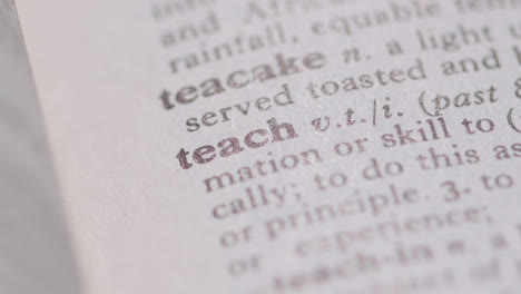 Close-Up-On-Page-Of-Dictionary-With-Definition-Of-Word-Teach