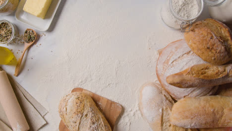 Overhead-Shot-Of-Freshly-Baked-Loaves-Of-Bread-On-Floured-Marble-Work-Surface-1