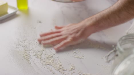 Flour-Being-Sieved-Onto-Marble-Work-Surface-For-Baking-With-Ingredients-1