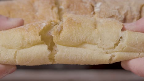 Close-Up-Studio-Shot-Of-Person-Tearing-Open-Fresh-Bread-Roll