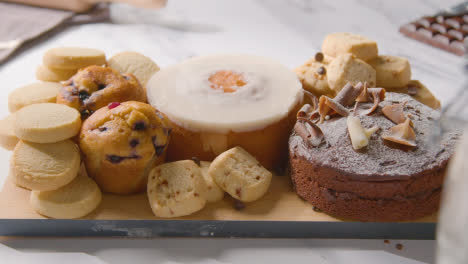 Tray-With-Homemade-Muffins-Cakes-And-Biscuits-From-Kitchen-Work-Surface