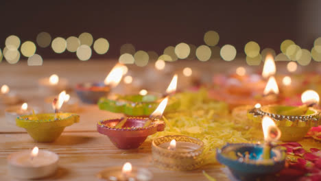 Brennende-Diya-Lampen-Auf-Einem-Tisch,-Der-Dekoriert-Ist,-Um-Das-Fest-Von-Diwali-1-Zu-Feiern