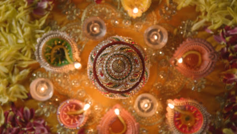 Overhead-Turntable-Shot-Of-Traditional-Coconut-Pot-On-Table-Decorated-For-Festival-Of-Diwali