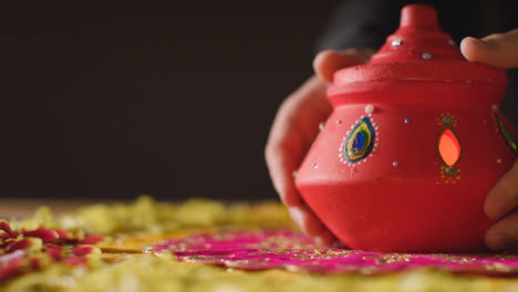 Traditional-Clay-Pot-With-Tea-Lights-On-Table-Decorated-For-Celebrating-Festival-Of-Diwali
