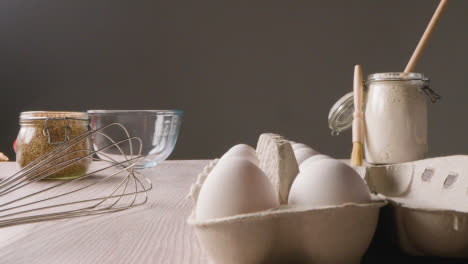Studio-Shot-Of-Baking-Ingredients-And-Utensils-On-Kitchen-Worktop
