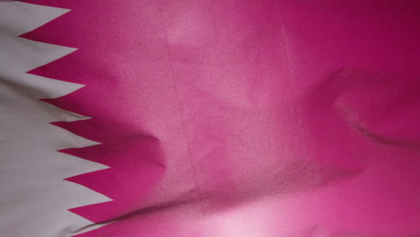 Close-Up-Studio-Shot-Of-Qatari-Flag-Flying-Filling-Frame