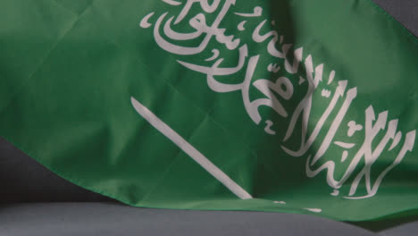 Close-Up-Of-Flag-Of-Saudi-Arabia-Draped-Over-Sofa-At-Home-Ready-For-Match-On-TV
