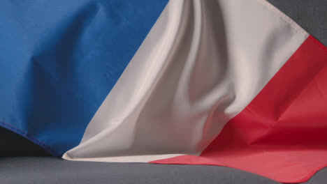 Close-Up-Of-Flag-Of-France-Draped-Over-Sofa-At-Home-With-Football-Ready-For-Match-On-TV