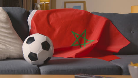 Flag-Of-Morocco-Draped-Over-Sofa-At-Home-With-Football-Ready-For-Match-On-TV-1