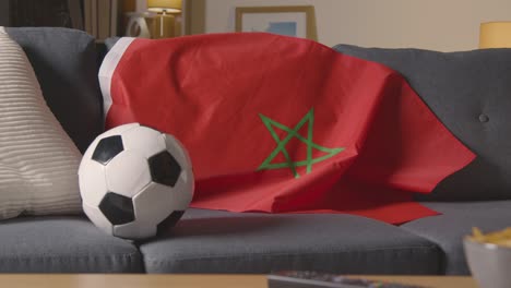 Flag-Of-Morocco-Draped-Over-Sofa-At-Home-With-Football-Ready-For-Match-On-TV-1