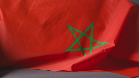 Close-Up-Of-Flag-Of-Morocco-Draped-Over-Sofa-At-Home-Ready-For-Match-On-TV