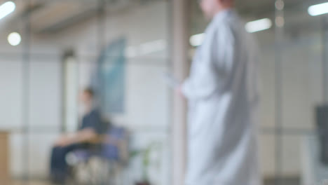 Defocused-Background-Shot-Of-Doctor-Working-In-Hospital-Meeting-With-Patient-