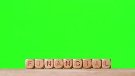 Business-Concept-Wooden-Letter-Cubes-Or-Dice-Spelling-Financial-Against-Green-Screen