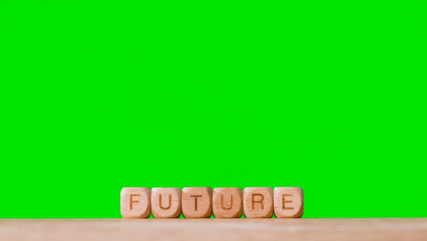 Education-Concept-With-Wooden-Letter-Cubes-Or-Dice-Spelling-Future-Against-Green-Screen-Background