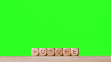Education-Concept-With-Wooden-Letter-Cubes-Or-Dice-Spelling-Future-Against-Green-Screen-Background