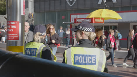 Female-Police-Officers-Outside-The-Emirates-Stadium-Home-Ground-Arsenal-Football-Club-London-With-Supporters-On-Match-Day