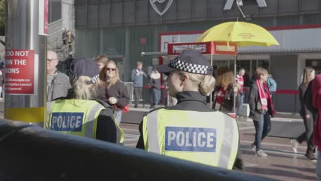 Female-Police-Officers-Outside-The-Emirates-Stadium-Home-Ground-Arsenal-Football-Club-London-With-Supporters-On-Match-Day
