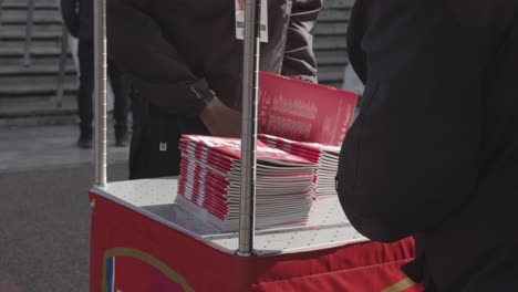 Stall-Selling-Match-Programmes-Outside-The-Emirates-Stadium-Home-Ground-Arsenal-Football-Club-London-With-Supporters