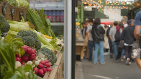 Stall-Selling-Fresh-Vegetables-Inside-Borough-Market-London-UK-With-Tourist-Visitors-1