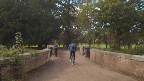 Autumn-View-Of-Bridge-In-Bute-Park-In-Cardiff-Wales-With-Cyclists-1