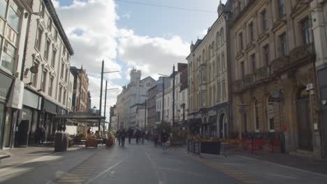 Walking-Along-Pedestrianised-Street-In-Cardiff-City-Centre-Wales-With-Tourists