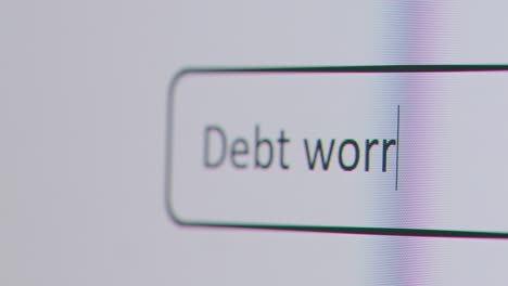 Close-Up-Of-Screen-With-Person-Typing-Debt-Worries-Into-Computer-Search-Engine