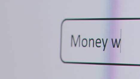 Close-Up-Of-Screen-With-Person-Typing-Money-Worries-Into-Computer-Search-Engine