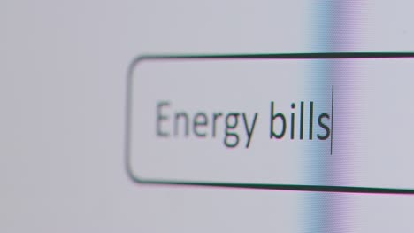 Close-Up-Of-Screen-With-Person-Typing-Energy-Bills-Into-Computer-Search-Engine