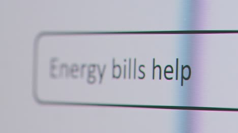 Close-Up-Of-Screen-With-Person-Typing-Energy-Bills-Help-Into-Computer-Search-Engine