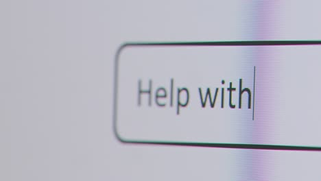 Close-Up-Of-Screen-With-Person-Typing-Help-With-Bills-Help-Into-Computer-Search-Engine