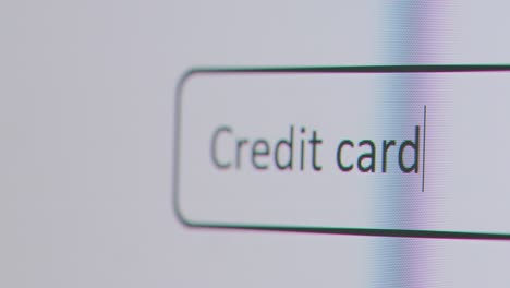 Close-Up-Of-Screen-With-Person-Typing-Credit-Card-Into-Computer-Search-Engine