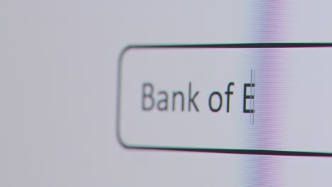 Close-Up-Of-Screen-With-Person-Typing-Bank-Of-England-Into-Computer-Search-Engine