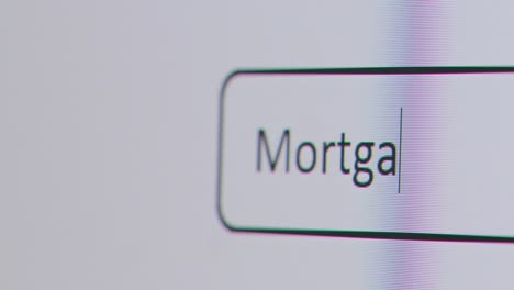 Close-Up-Of-Screen-With-Person-Typing-Mortgage-Calculator-Into-Computer-Search-Engine