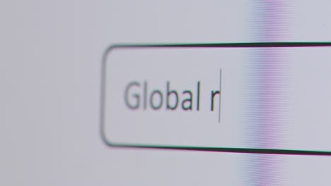Close-Up-Of-Screen-With-Person-Typing-Global-Recession-Into-Computer-Search-Engine