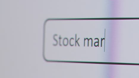 Close-Up-Of-Screen-With-Person-Typing-Stock-Market-News-Into-Computer-Search-Engine
