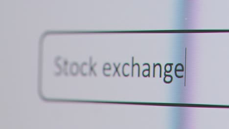 Close-Up-Of-Screen-With-Person-Typing-Stock-Exchange-Into-Computer-Search-Engine