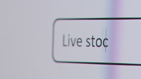 Close-Up-Of-Screen-With-Person-Typing-Live-Stock-Market-Into-Computer-Search-Engine