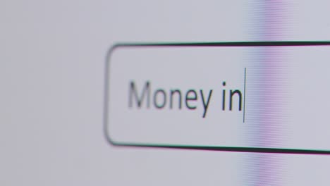 Close-Up-Of-Screen-With-Person-Typing-Money-Investment-Into-Computer-Search-Engine