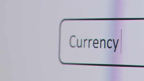 Close-Up-Of-Screen-With-Person-Typing-Currency-Converter-Into-Computer-Search-Engine