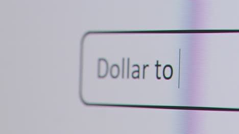 Close-Up-Of-Screen-With-Person-Typing-Dollar-To-Pound-Into-Computer-Search-Engine