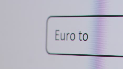 Close-Up-Of-Screen-With-Person-Typing-Euro-To-US-Dollar-Into-Computer-Search-Engine