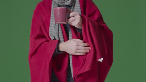 Close-Up-Of-Person-Wearing-Blanket-And-Scarf-With-Hot-Drink-Trying-To-Keep-Warm-In-Energy-Crisis