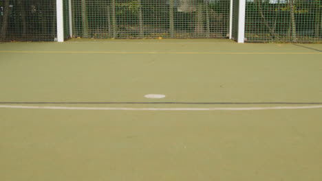 View-Of-Goal-On-Empty-Artificial-Soccer-Pitch-In-Urban-City-Area
