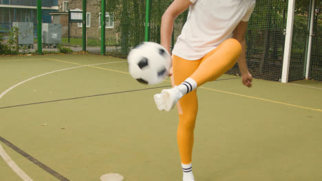 Mujer-Joven-En-Un-Campo-De-Fútbol-Artificial-En-El-área-Urbana-De-La-Ciudad-Con-Control-Y-Patadas-De-Fútbol-1